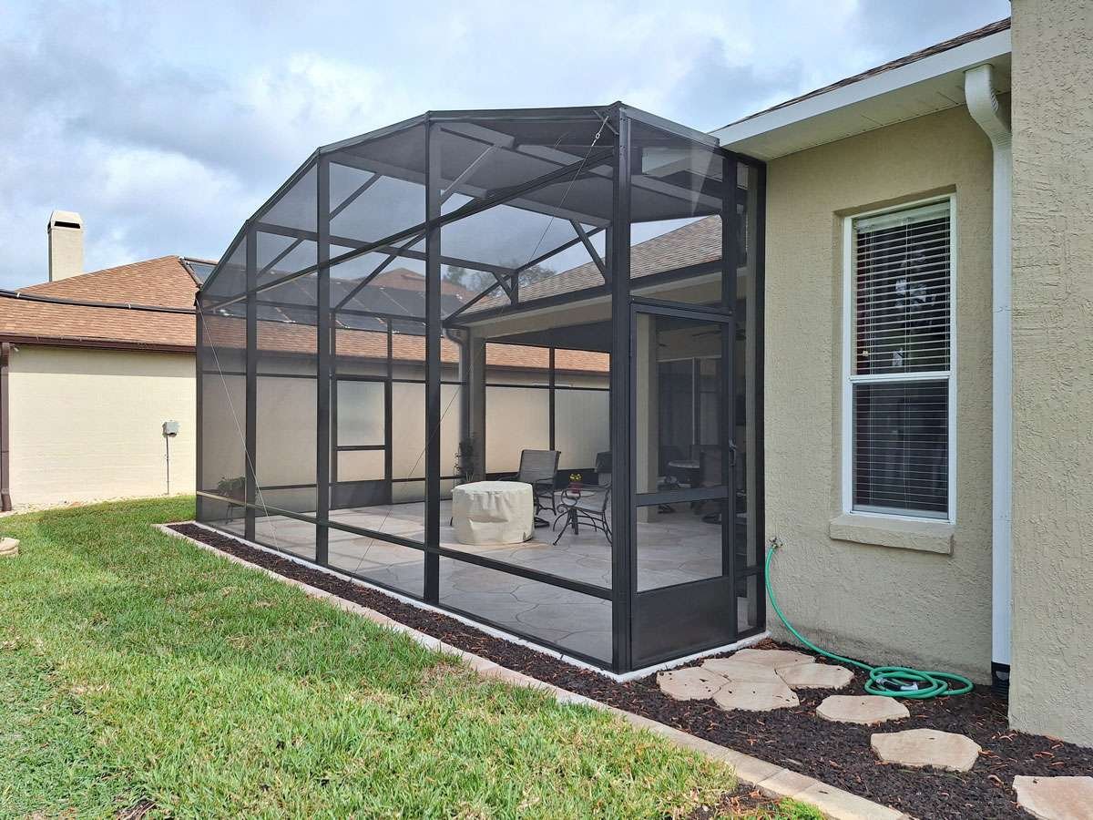 residential lanai screen enclosure installation in Tallahassee, FL attached to home